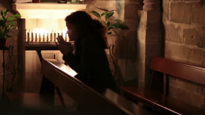 stock-footage-woman-praying-in-church